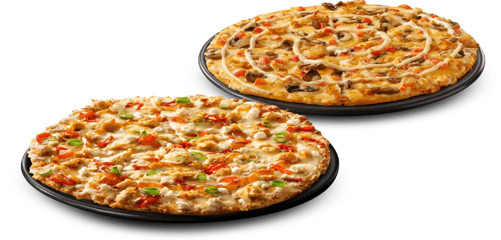 2 large pizzas on black plates