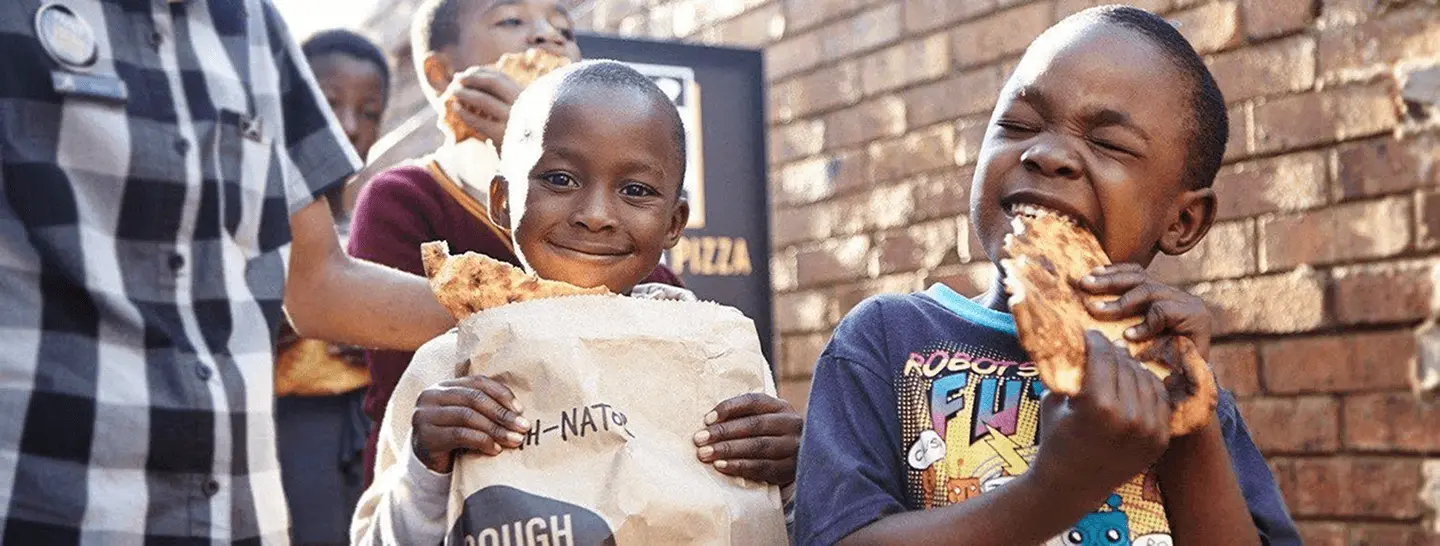 Kids enjoying their Pizza douhnation