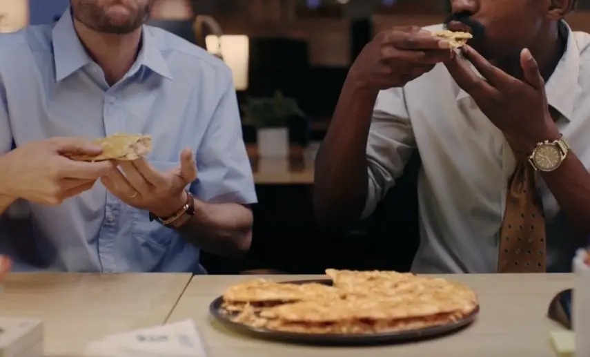 Work friends sharing a pizza