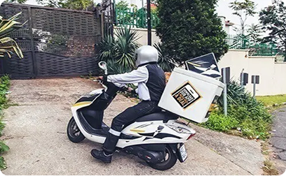 Pizza delivery person on a scooter