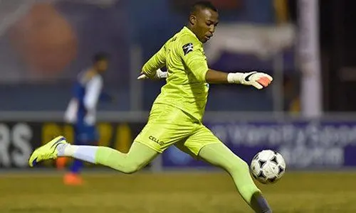 Soccer player kicking a ball on the field