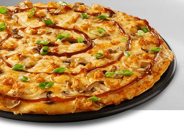 Large pizza on a black plate