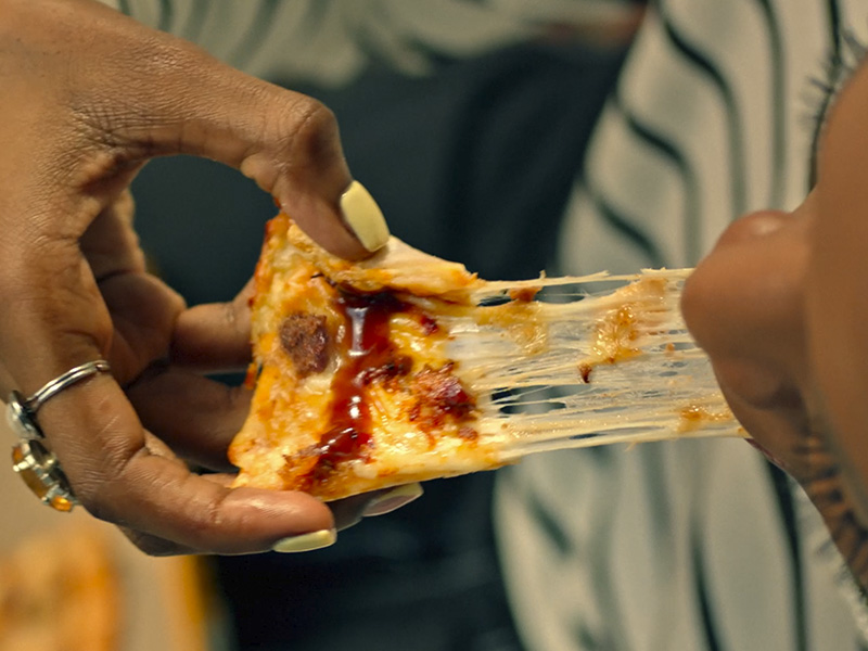 Pizza slice with stringy cheese