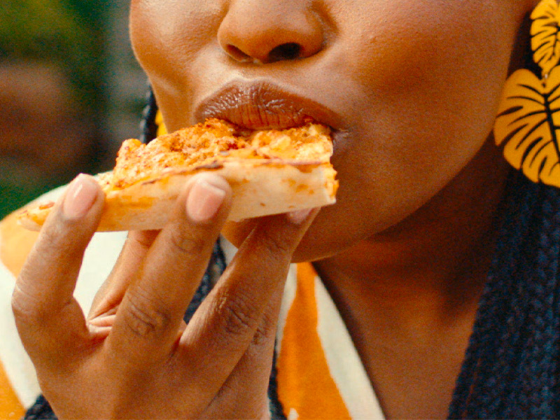 Person eating on the double pizza slice