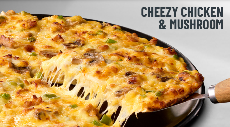 Cheezy chicken & mushroom pizza on a black slate
