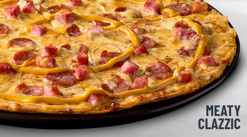 Meaty clazzic pizza on a black slate