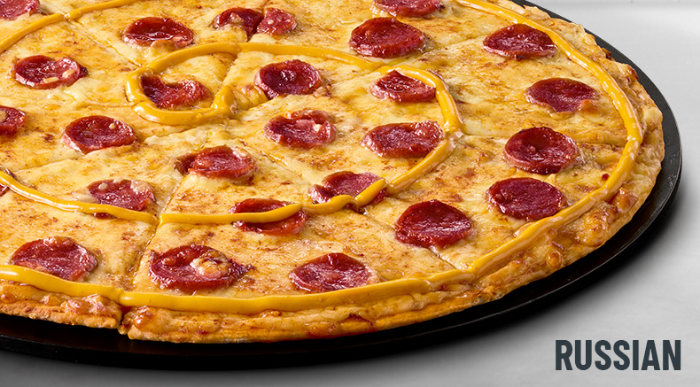 Russian halaal pizza on a black plate
